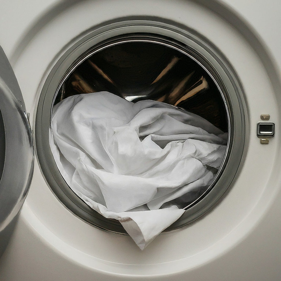 White bed sheet in washing machine